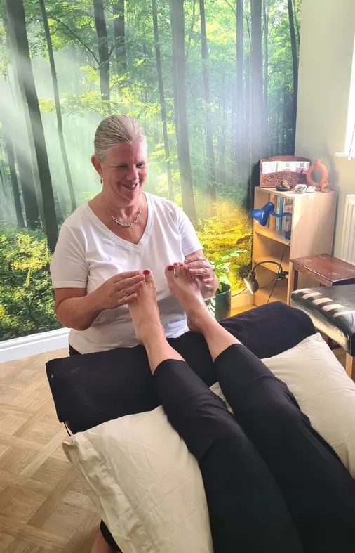 Jeanne Bradley performing reflexology on client